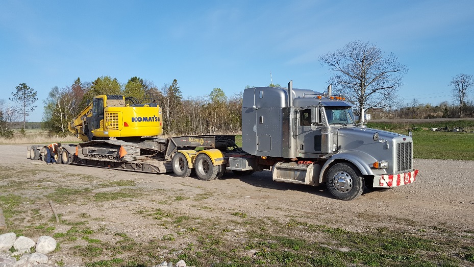 Truck and Trailer hauling construction equipment